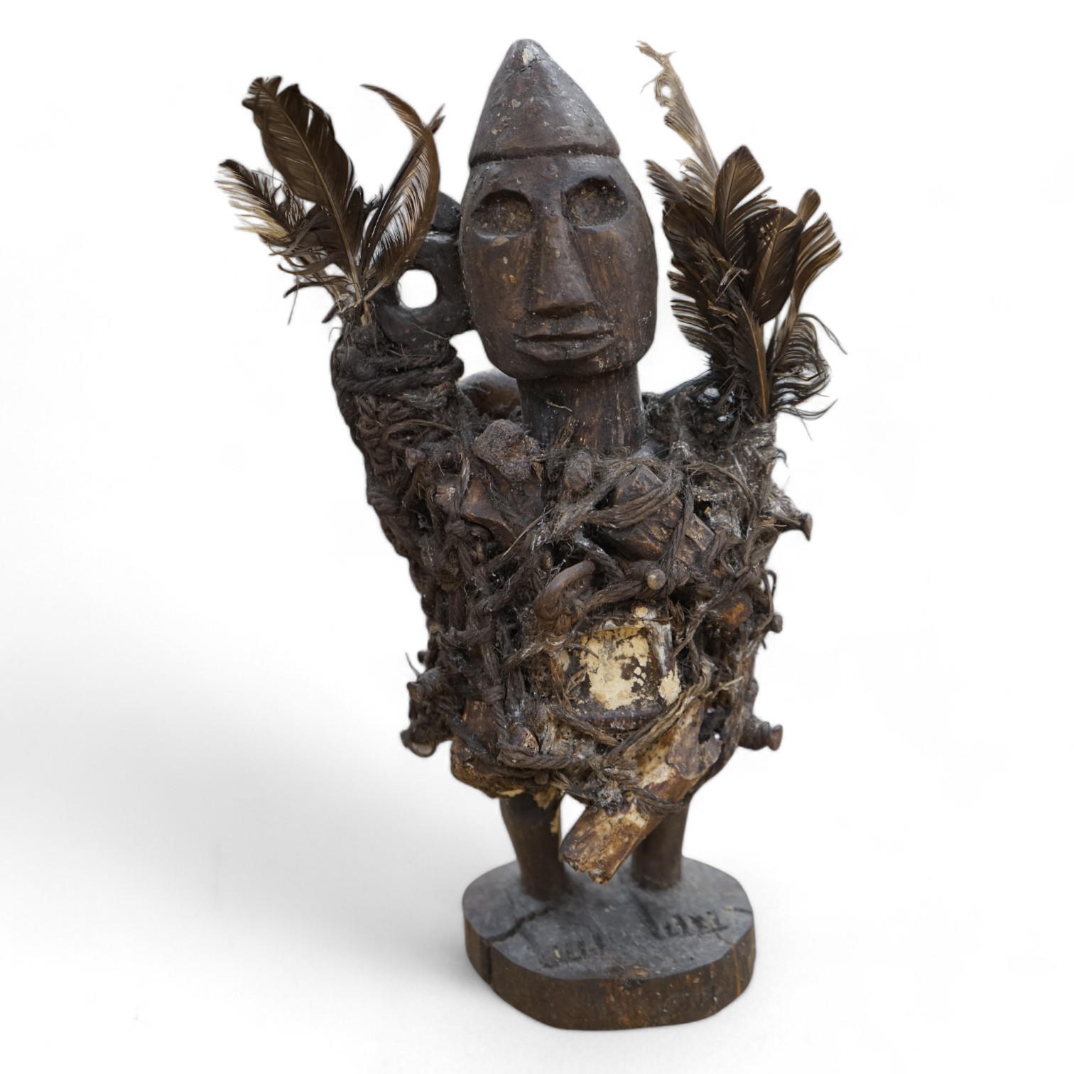 A Congo wood, feather and bone fetish figure, 39cm high. Condition - fair